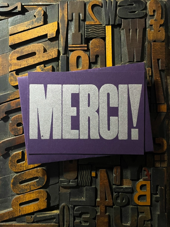 Merci! A beautiful typographic letterpress postcard printed with metallic silver inks printed on rich thick  colourful card with a luxury matching envelope; ideal to send a thank you note to a friend or loved one.