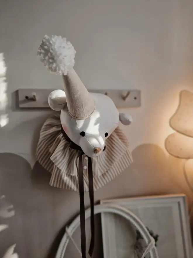 Bear Head Nursery Decoration, a bear decoration sitting against a wall in a child's decorated bedroom. 