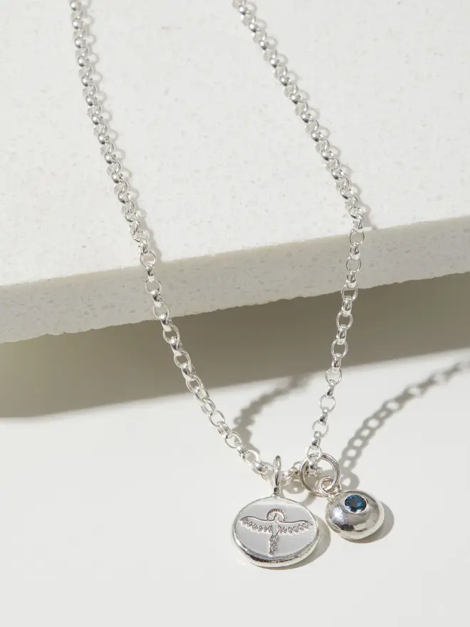 Close up of a Sterling silver Phoenix Pebble Necklace with a birthstone charm