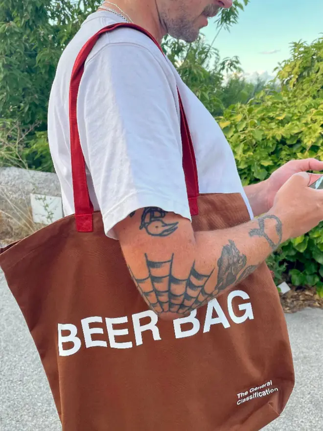 'Beer Bag' Tote Bag, worn by a man with tattoos.