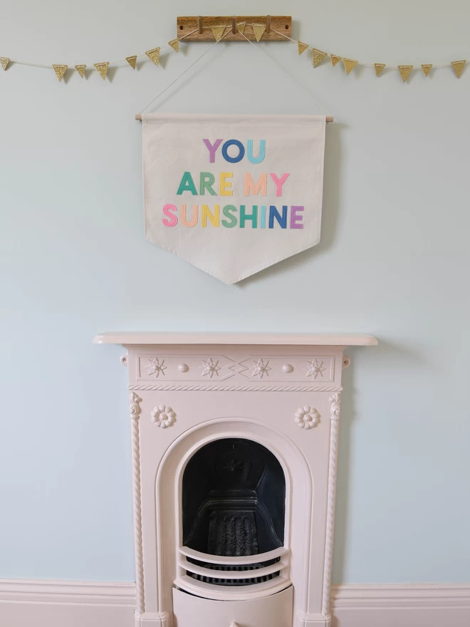 wall hanging with you are my sunshine written on in rainbow pastel 