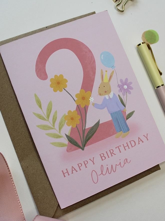 personalised floral 2nd birthday card. pink 2nd birthday card with illustrated rabbit and flowers.