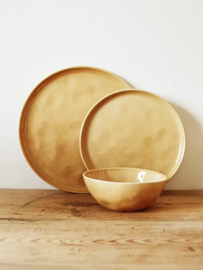 stoneware place setting dining set. a yellow plate and bowl dining set.