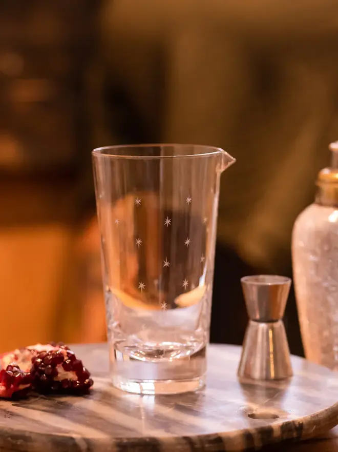 engraved stars crystal mixing glass. a crystal cocktail glass patterned with small stars.