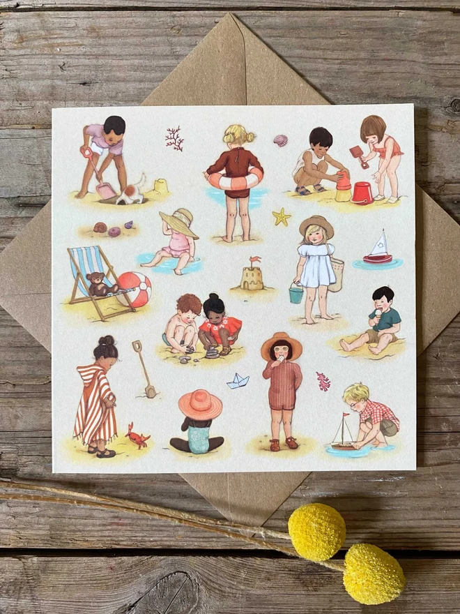 anillustarted greeting card featuring storybook style children playing on a beach