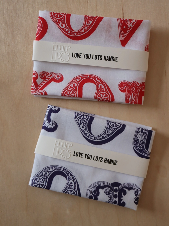 Two folded Mr.PS Love You Lots hankies to show the colour options available: red and violet