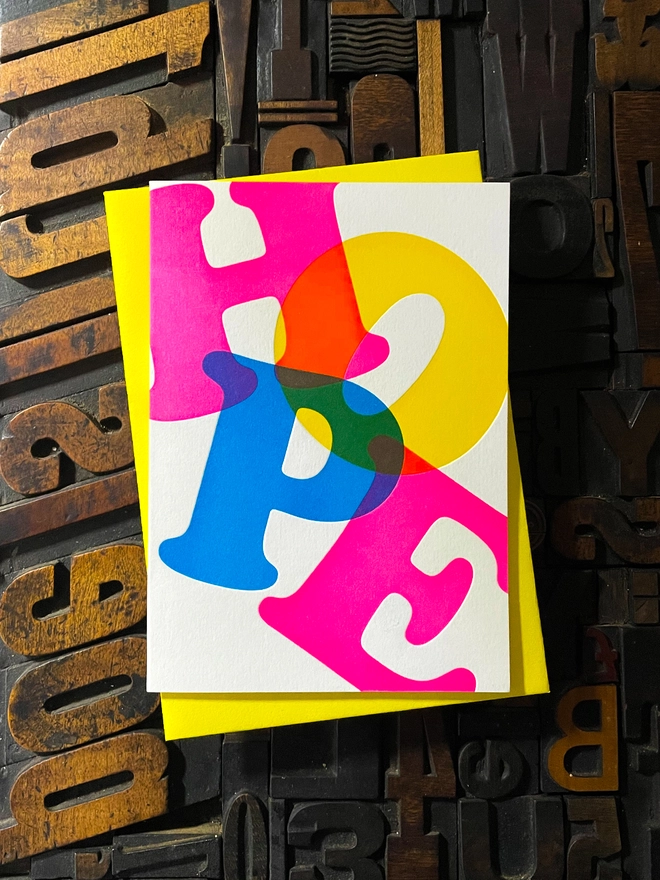 Noel, Joy, Hope; A beautiful typographic set of letterpress Christmas cards. Printed with rich vibrant and fluorescent blue, magenta and yellow inks with luxury matching and contrasting envelopes; ideal to send to your designer friends at the festive season.