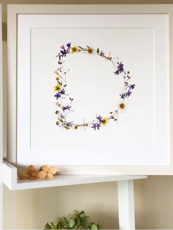 Pressed Wildflower Letter Print, a wildflower alphabet letter print sitting framed. 