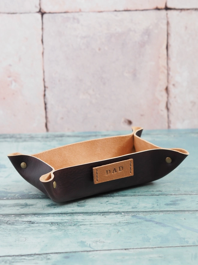 Hand dyed dark brown leather valet tray. A personalised dish with the name tag DAD stitched to one side.