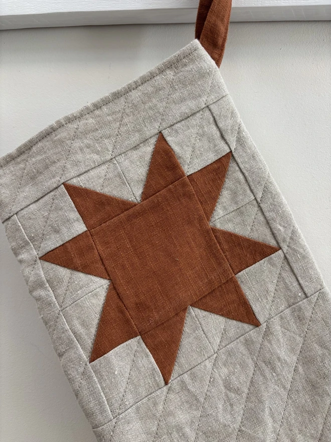 Rust Linen Star Detail on Natural Linen Quilted Christmas Stocking.