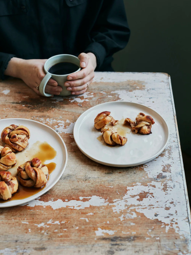 small stoneware plates (set of 2). two round white plates holding pastries.