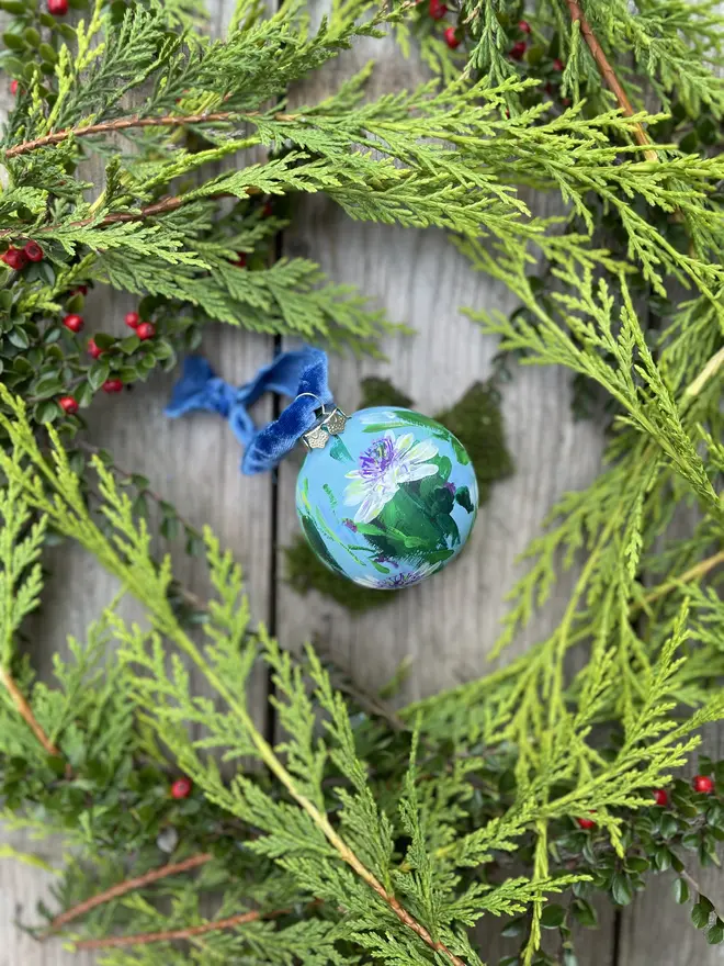 a set of six hand vibrant painted floral ceramic baubles all painted with an array of winter florals each finished with a luxurious velvet ribbon 