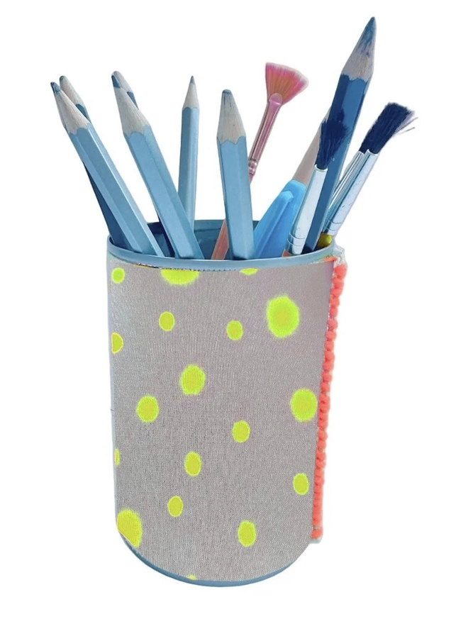 Upcycled & Repurposed Linen Tin Holder Polka Dot Print, a colourful polka dot tin on a white surface with pens and brushes in it. 