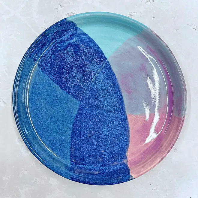 Landscape Dinner Plate, a colourful plate placed on a stone surface. 