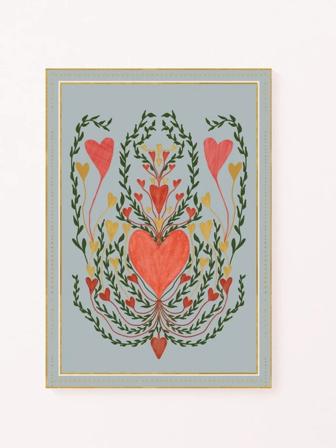 Love In Blue Art Print, a colourful print hanging on a wall. It has a heart motif. 