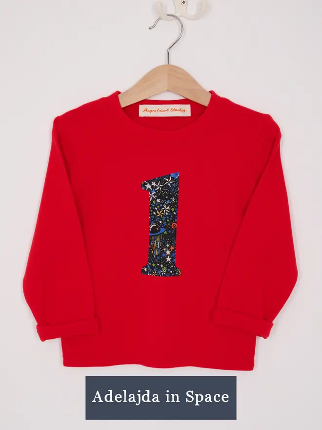 a red long sleeve cotton t-shirt appliquéd with a number 2 in Liberty print featuring stars and space planets