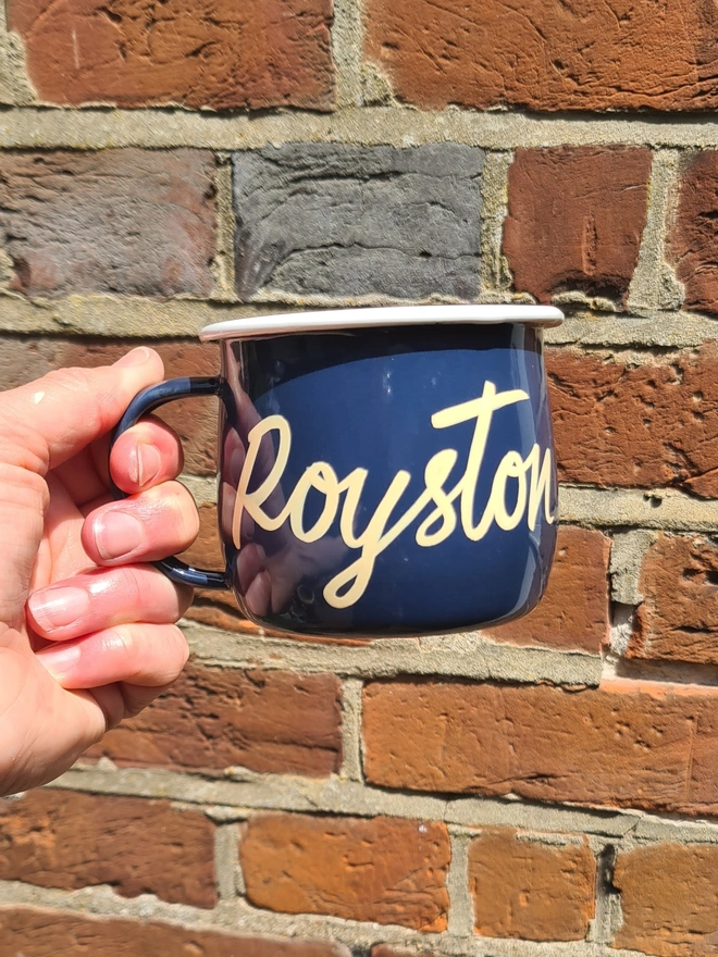 blue mug with cream 'royston' text