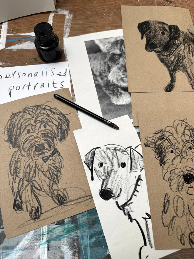 drawings of dogs on brown paper on a drawing board