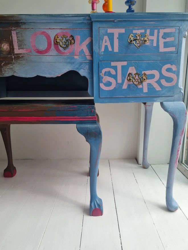 Painted desk and stool in blue and brown with floral decoupage and text reads in pink; 'look at the stars'.