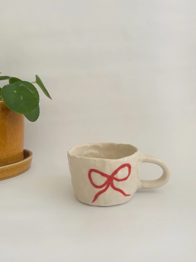 red bow ceramic mug