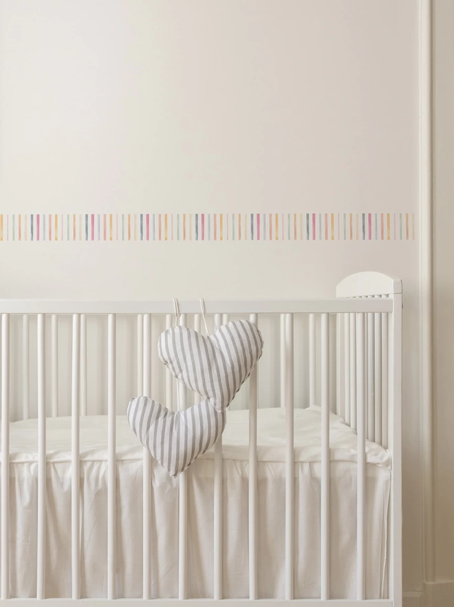 Close up of Candy Stripe Self Adhesive Border Sticker Decal above baby cot