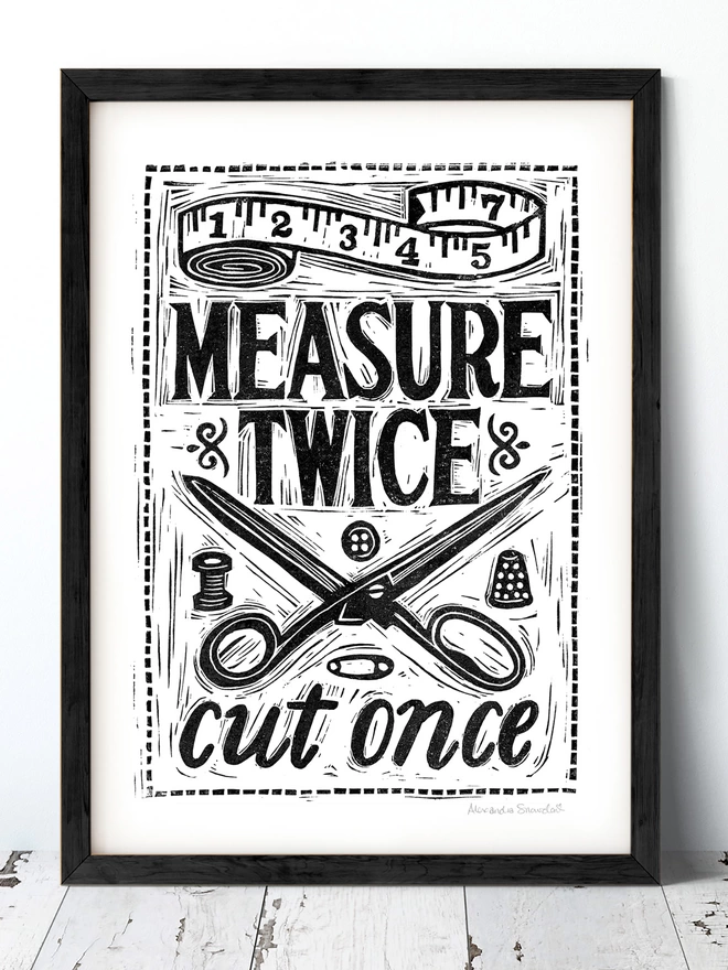 black and white sewing print with scissors in a black frame