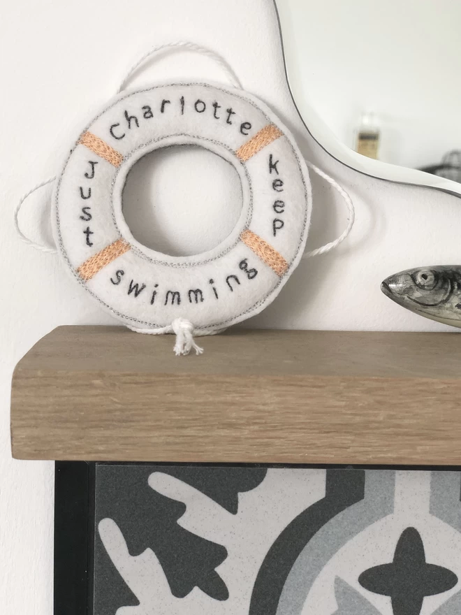 Just Keep Swimming Personalised Life Saver Ring on bathroom shelf with mirror and fish
