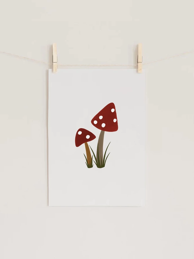 Toadstool Art Print hung with pegs