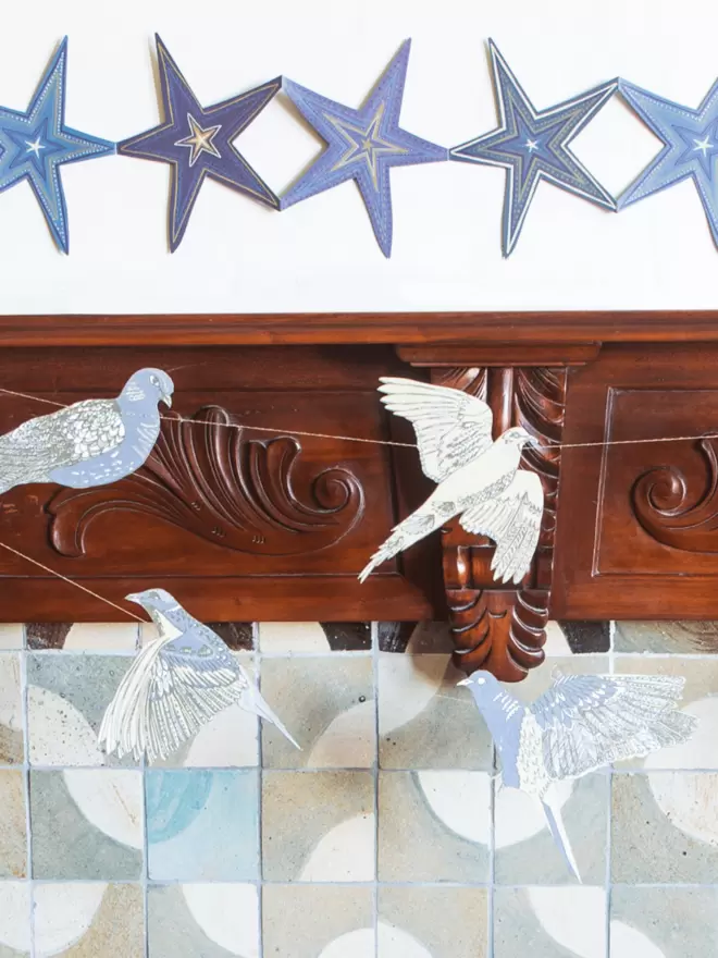 Close up of grey and blue dove hanging over wooden fireplace