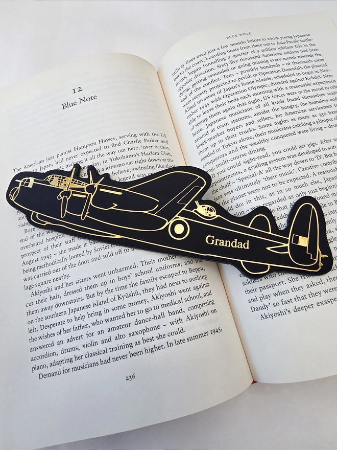 black and gold leather Lancaster airplane bookmark personalised with grandad in gold on an open book