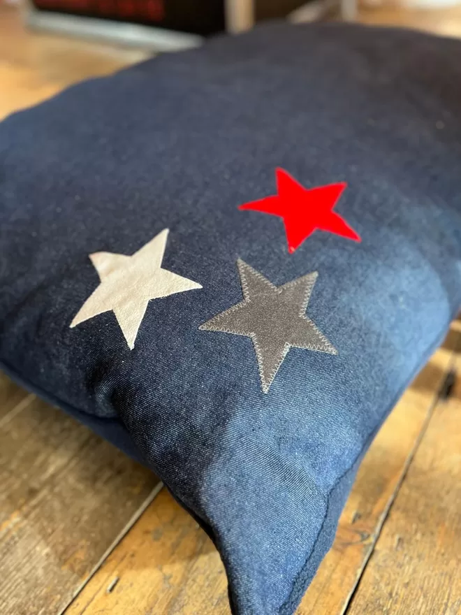 Denim Star Dog Bed with red polar fleece underside