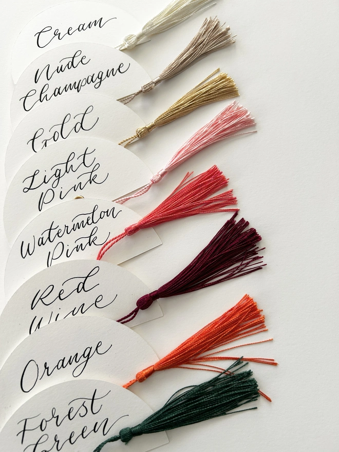 Half circle calligraphy place cards with tassels