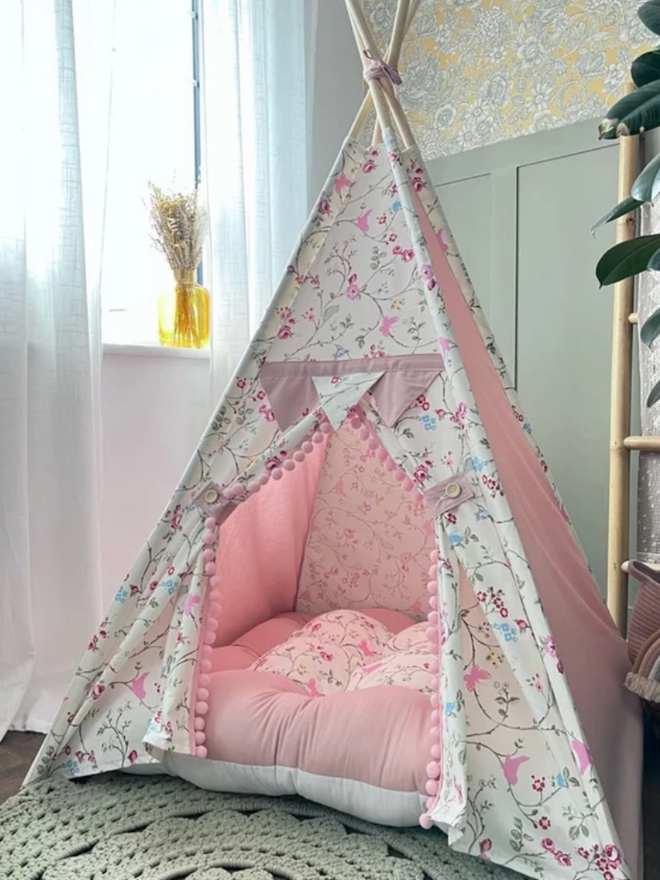 Pink Flowery Kids’ Teepee. A teepee patterned with pink flowers in a child’s bedroom.