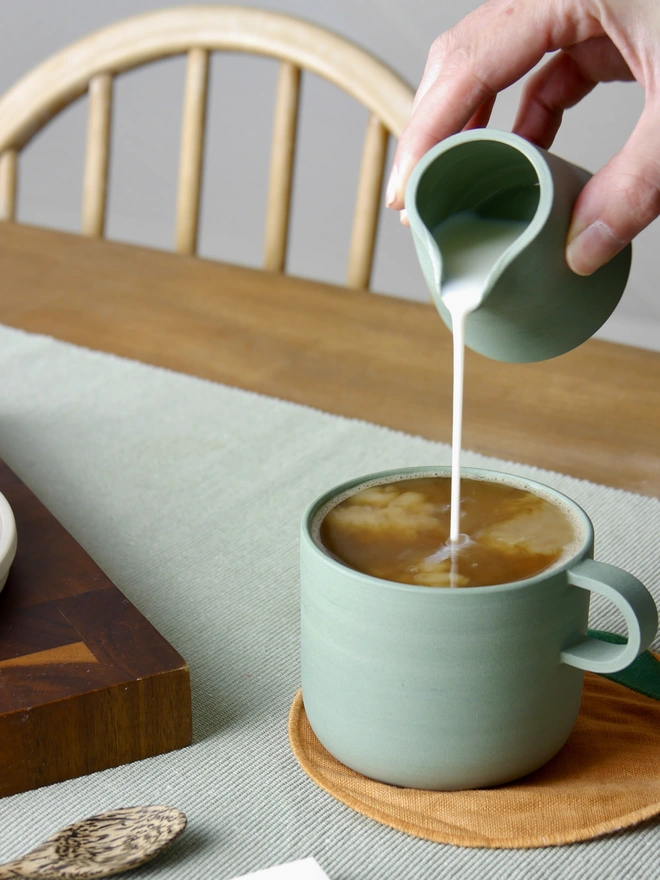 Ceramic Milk Jug green being poured