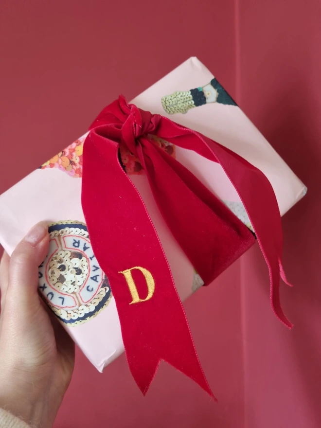 A red velvet ribbon tied around a gift
