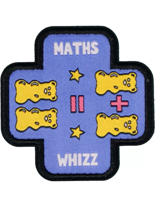 Patch in the shape of a plus sign. Maths Whizz written in white lettering. Across the middle is an equation formed of yellow gummy bears and pink plus and equal signs.
