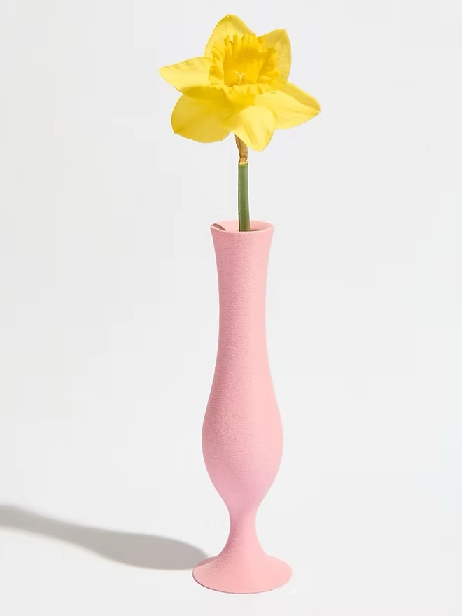 pink 3d printed vase in flute shape with yellow flower