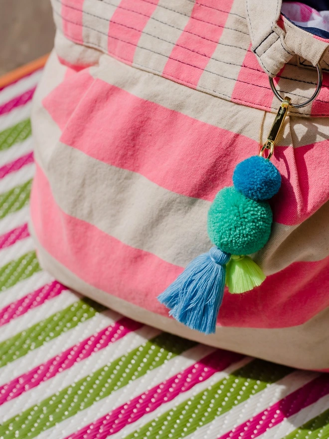 pom pom and tassel keyring bag charm in sea blue colours and sturdy gold clip