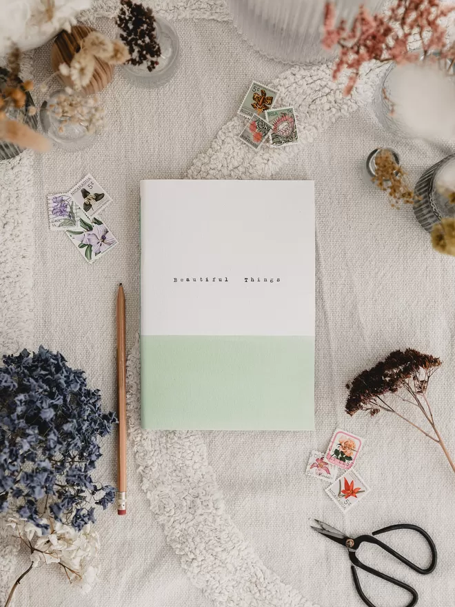 soft green and white gratitude journal with the words 'beautiful things' typed on the cover