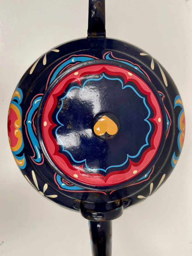 Large dark blue vintage enamel teapot, hand-painted with a oink, orange a yellow fairground inspired design. 'Wonderful' is painted in a banner across the centre of the design.