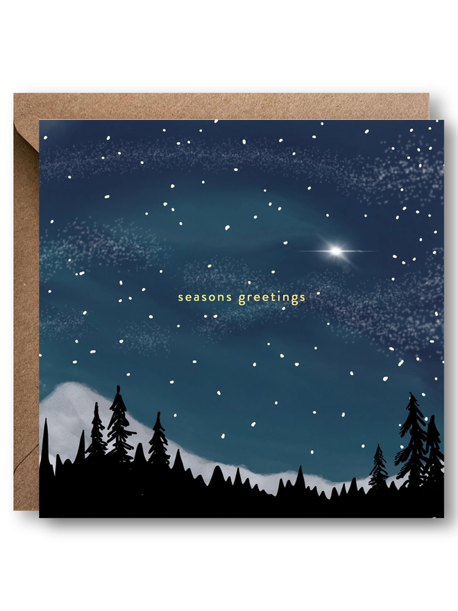 Seasons Greetings Christmas card with a view of the night sky. Shows a forest outline with mountains and the North Star