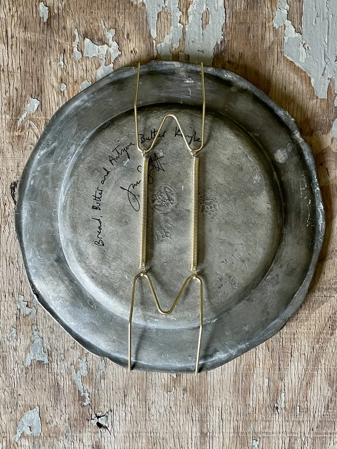 plate hanger on back of pewter plate