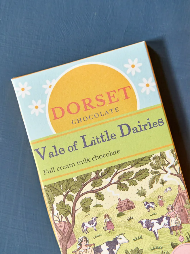 dorset chocolate milk chocolate bar with 'vale of little daisies' title and illustration of farm with various animals