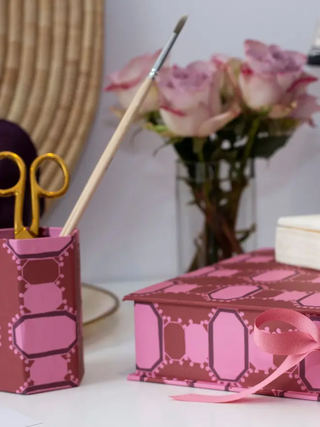 Hexagonal Brush Pot, a colourful patterned pencil pot sitting on a white surface accompanied by some desk accessories. 
