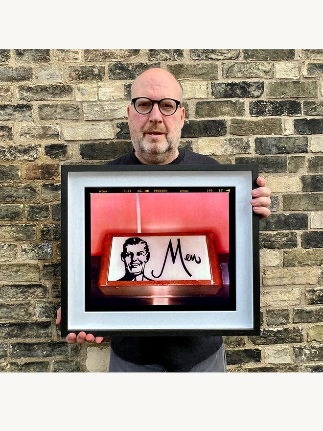Richard Heeps holding Men Pink Typography Photography Print framed in black