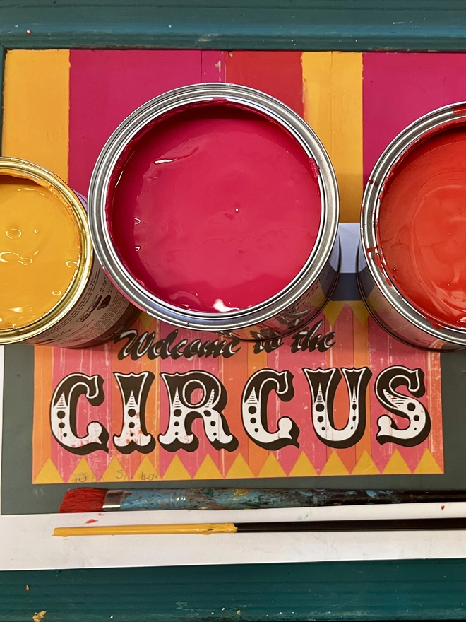Annie sloan colour choices for the welcome to the circus sign in pink, orange and red with a teal frame 