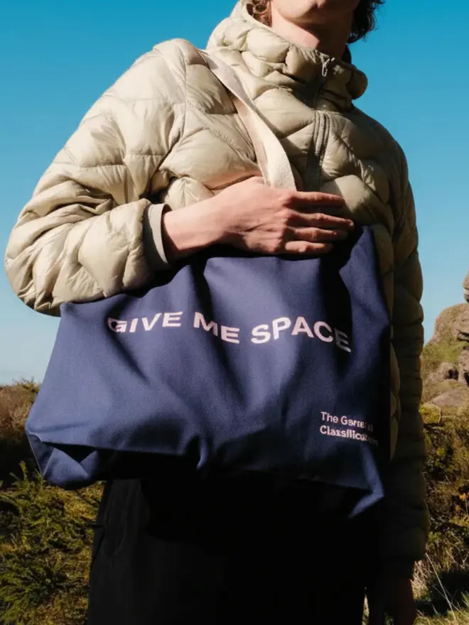 'Fragile' Oversized Tote Navy, being worn. 