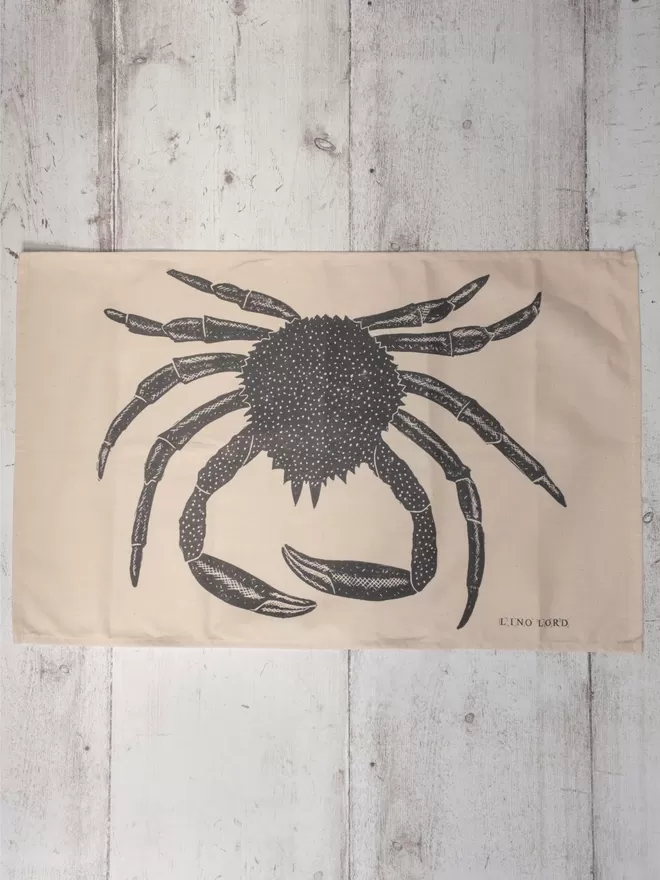 Picture of a tea towel with an image of a spider crab, taken from an original lino print