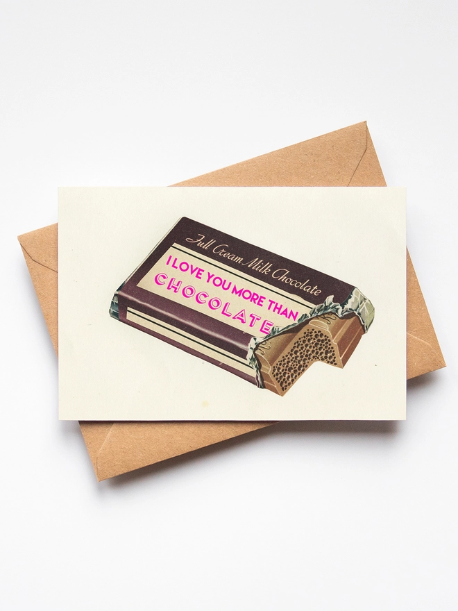 A greeting card depicting a purple chocolate bar and the words I Love You More Than Chocolate.