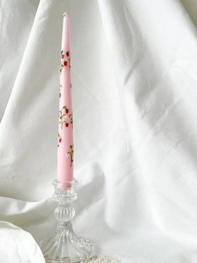 Wild Strawberry Pink Hand Painted Candle, a pink candle in a glass vase sitting against a white backdrop. 